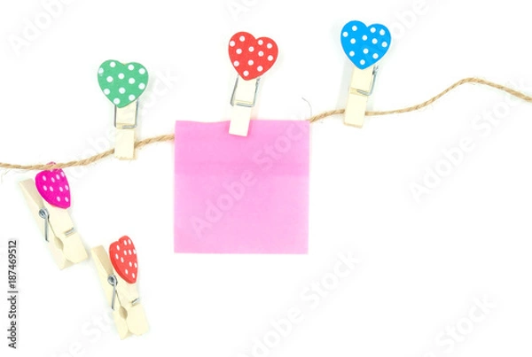 Fototapeta colorful clothespin with heart shape design and pink  paper sheet and rope for valentine concept isolated on white background . Space for text and images .
