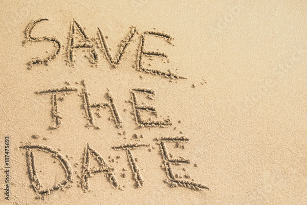 Fototapeta Save the Date text written on the sand