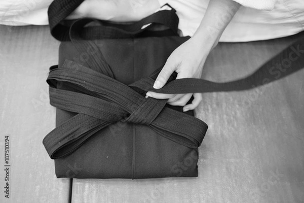 Fototapeta The training participant adds the underside of the hakama aikido clothing