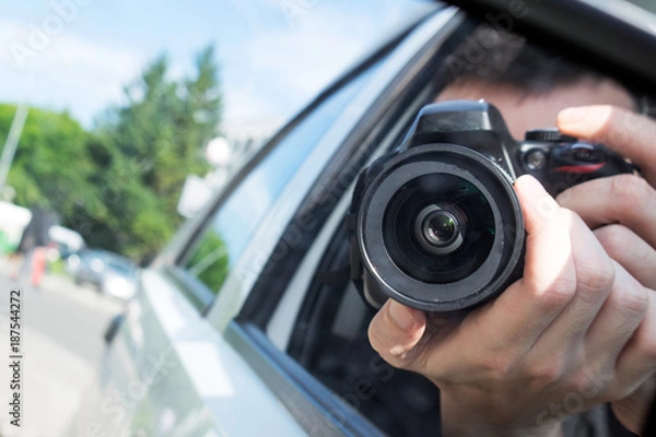 Fototapeta photographer with camera take photo from the car window