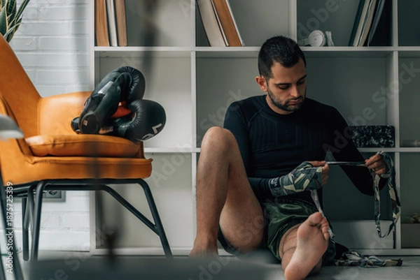 Obraz boxer putting on a boxing hand wrap
