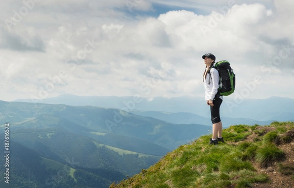 Fototapeta Tourist relax on the mountain top. Sport and active life concept