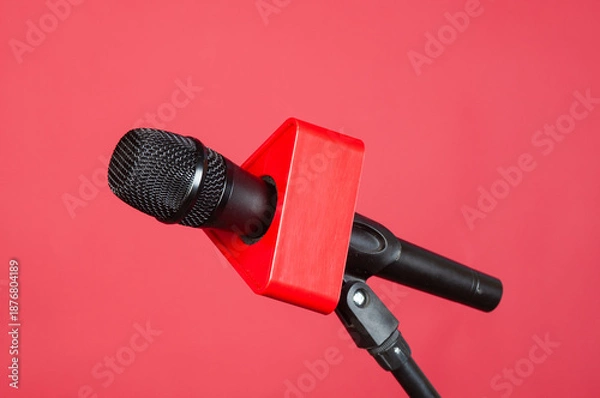 Obraz Wireless microphone with stand on a red background