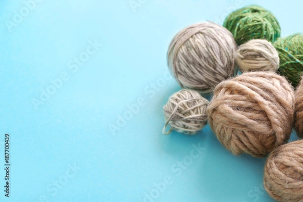 Fototapeta Set of woolen clews on color background