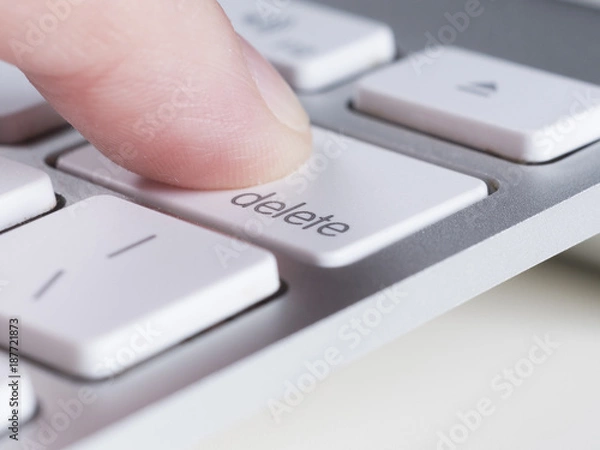 Fototapeta Finger is pressing delete key of computer keyboard
