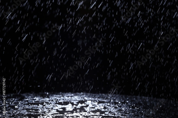 Fototapeta Dark background shot of rain falling