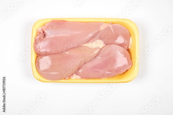 Fototapeta Raw chicken fillet package isolated on white background.