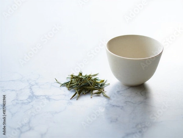 Obraz Tea leaves and empty white ceramic cup on marble surface