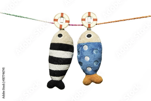 Fototapeta two pillows fish shape hanging on the rope isolated on white background