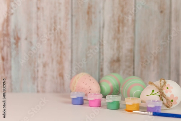 Fototapeta Easter eggs, paints and a brush. Easter background. Coloring Easter eggs