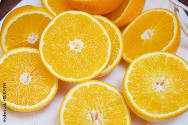 Obraz sliced ​​orange rings on a white background