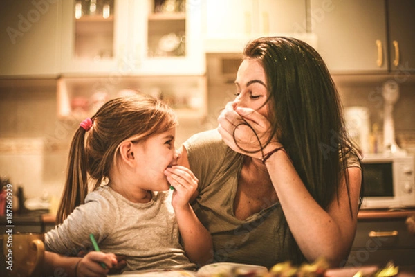 Fototapeta Mommy make me laughing. Little girl spending time with mother.