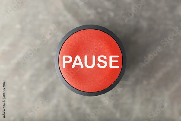 Fototapeta Overhead of Red Pause Button Over Blurred Gray Background