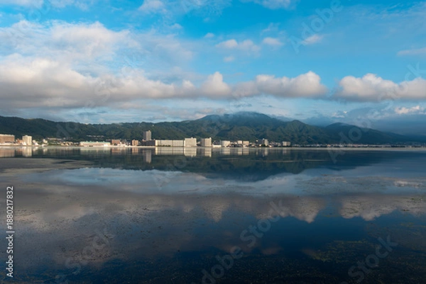 Obraz 早朝の静かな琵琶湖　大津市のマンション群と雲が湖面に映る風景
