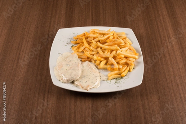 Obraz pork chops with white sauce and fried potatoes