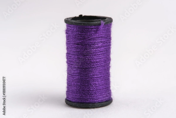 Obraz Spool purple thread on white background, closeup.