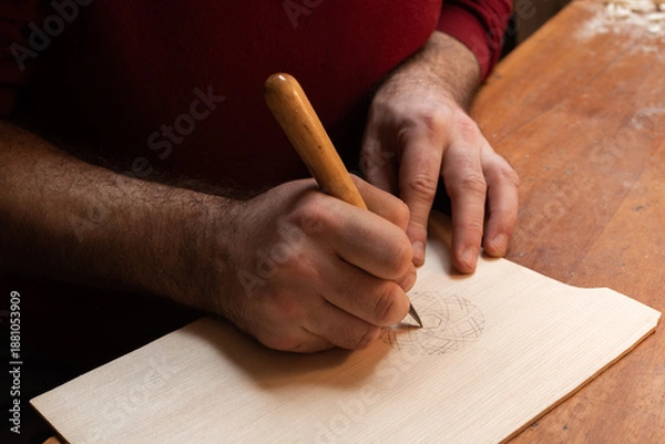 Obraz The master carves a pattern on the board