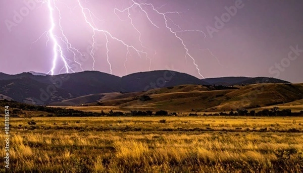 Obraz Dramatic Lightning Storm Over Rolling Hills and Golden Fields.