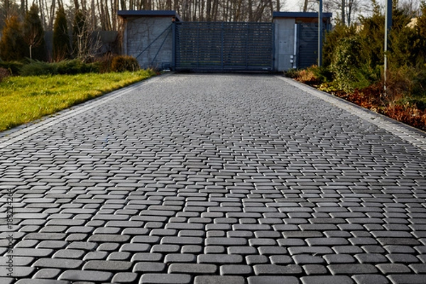 Obraz Cobblestone entrance in the garden, graphite paving stone texture, pavement