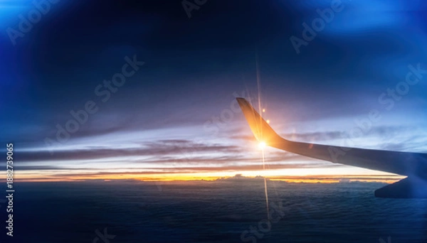 Obraz Wing at sunset through the window