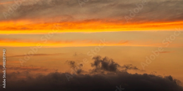 Obraz Beautiful bright orange sunset sky with clouds.