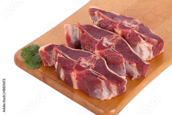 Obraz Fresh mutton on wooden board with parsley