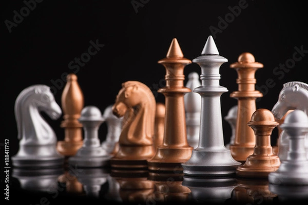 Fototapeta A series of gold and silver chess pieces