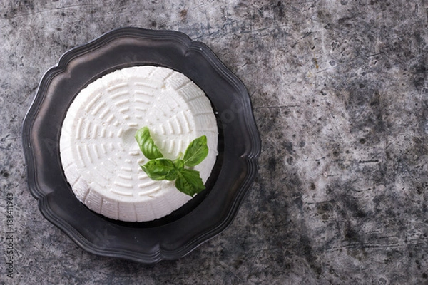 Obraz A fresh ricotta with basil leaf on wooden table italian food concept