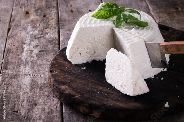 Obraz A fresh ricotta with basil leaf on wooden table italian food concept