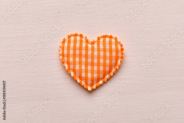 Obraz Orange fabric heart shape on light background