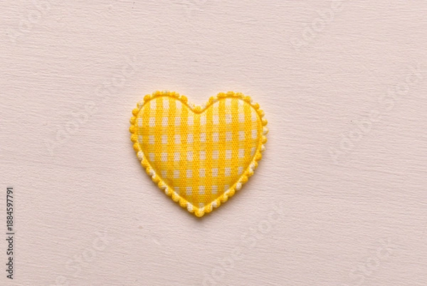 Obraz Yellow fabric heart shape on light background