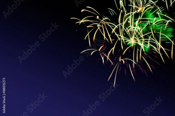 Fototapeta Colorful firework on the night sky. New Year celebration fireworks. Abstract firework isolated on black background with free space for text