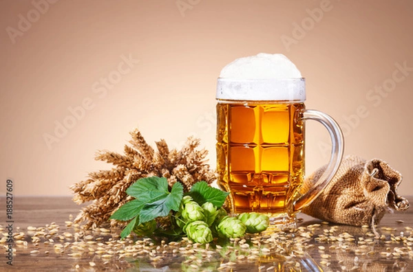 Fototapeta A mug of fresh beer and natural ingredients of brewing