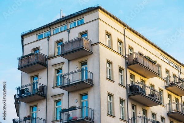 Obraz beautiful corner building with yellow facade