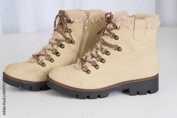 Obraz Tan boots on a white background
