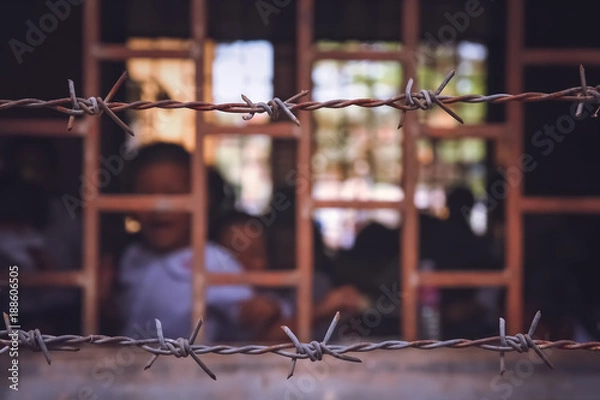 Fototapeta School behind barbed wires