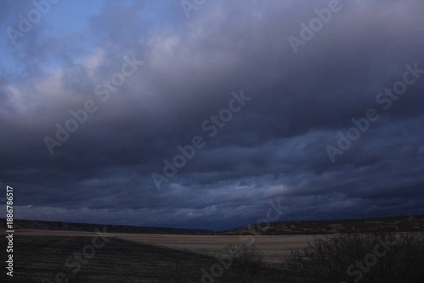 Obraz A Prairie storm clouds and setting sun. 