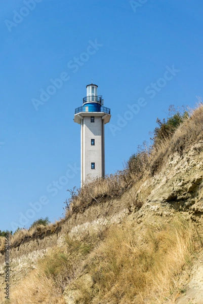 Obraz Lighthouse on the hill with blue empty sky