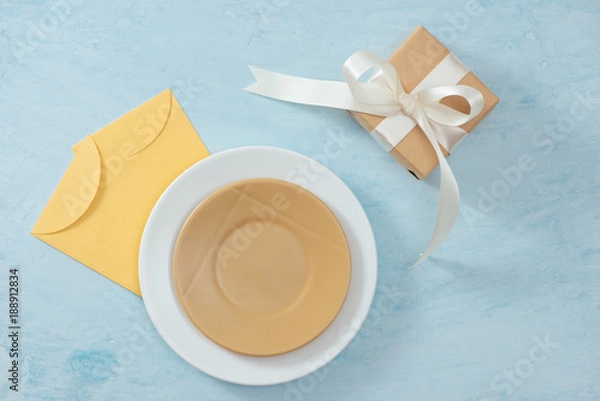 Obraz Tet Holiday Concept. Gold Envelope (Lucky money) on table with Table setting with Plate and Flowers.