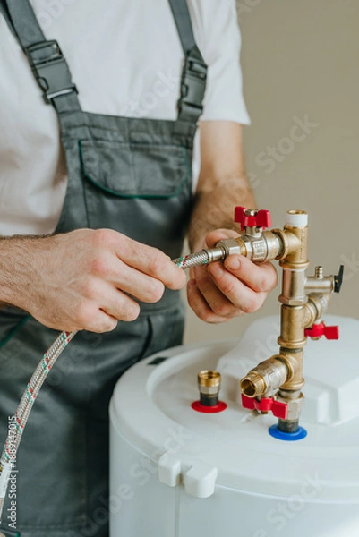 Obraz Man fixing water heater
