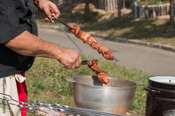 Fototapeta barbeque grill, skewers with meat, brazier, cauldron, chef controls willingness dishes