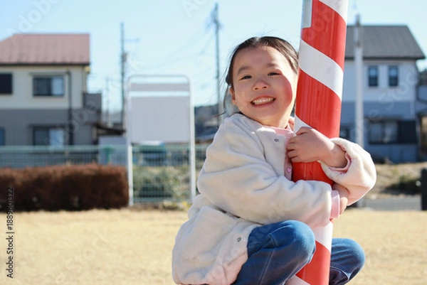 Obraz 冬の公園で遊ぶ女の子