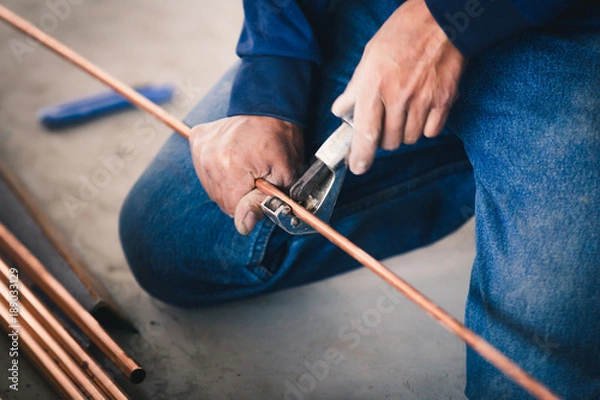 Obraz Industry system men worker cut joint with tool of copper pipe air conditioner