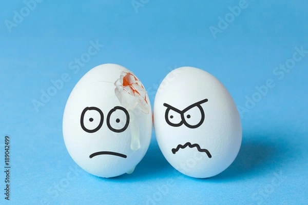 Obraz Drawing bodily injuries, fighting, finding out the relationship. Egg with a frustrated face because of a crack in the co-shell and an egg with an evil face