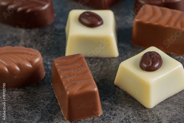 Obraz Assortment of chocolate candies sweets on a dark background