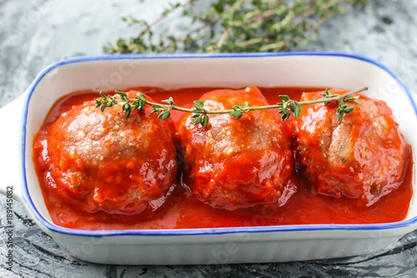 Obraz Raw meatballs from beef in tomato sauce with thyme