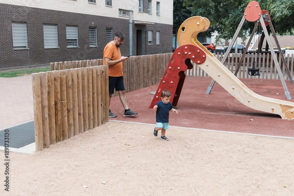 Obraz Father distracted by phone while son playing