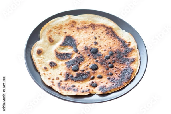 Obraz Burnt pancake presented on a plate, isolated