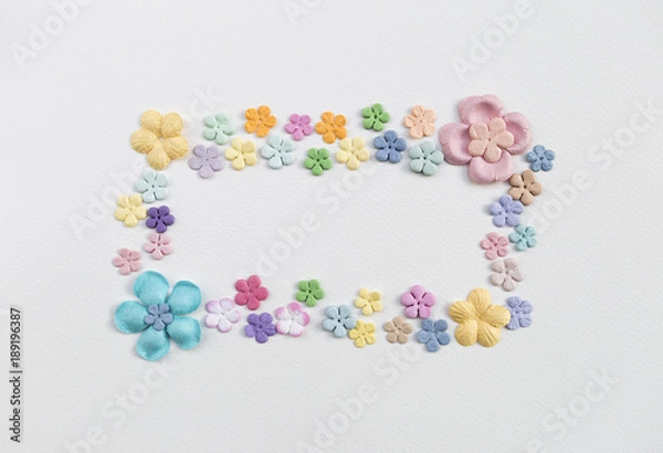 Fototapeta Beautiful color paper flower arrange in squre frame shape on white paper texture background, flower card background concept