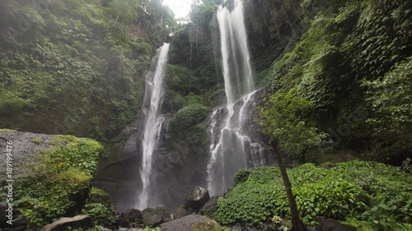 Obraz Waterfall in green rainforest. Triple waterfall Sekumpul in the mountain jungle. Bali,Indonesia. Travel concept.